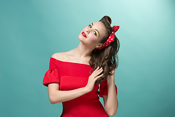 Image showing Beautiful young woman with pinup make-up and hairstyle. Studio shot on white background