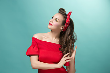 Image showing Beautiful young woman with pinup make-up and hairstyle. Studio shot on white background