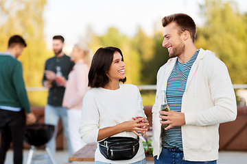 Image showing happy couple with drinks at rooftop party