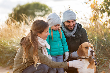 Image showing happy family with beagle dog outdoors in autumn