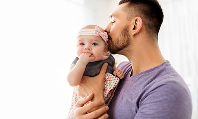 Image showing close up of father kissing little baby daughter