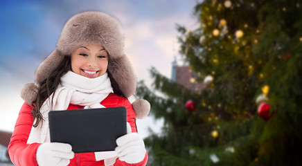 Image showing woman with tablet pc over christmas tree