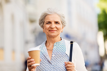 Image showing senior woman drinking coffee at summer city