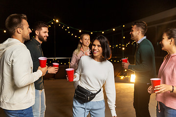 Image showing friends with drinks dancing at rooftop party