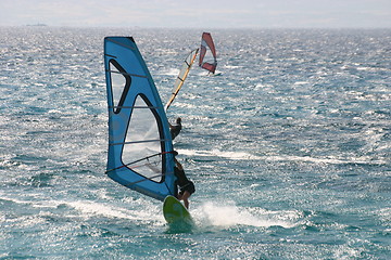 Image showing Three windsurfers at sea