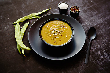 Image showing Creamy soup with green pea in a ceramic white plate