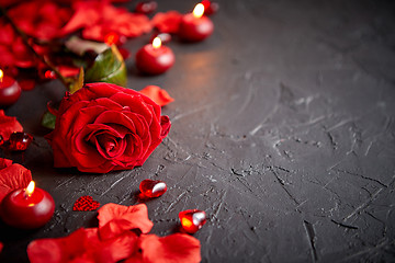 Image showing Red rose, petals, candles, dating accessories, boxed gifts, hearts, sequins