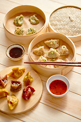 Image showing Traditional chinese dumplings served in the wooden bamboo steamer