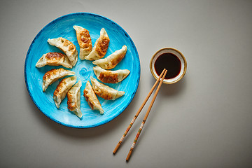 Image showing Traditional asian dumplings Gyozas on turqoise ceramic plate