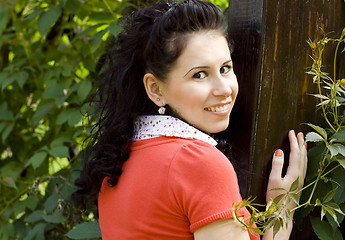 Image showing smiling woman in red