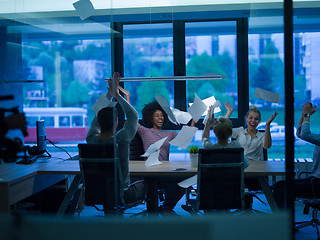 Image showing multiethnic Group of young business people throwing documents