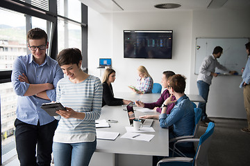 Image showing Two Business People Working With Tablet in office