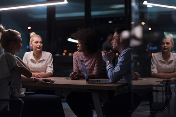 Image showing Multiethnic startup business team in night office