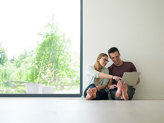 Image showing couple using laptop on the floor at home