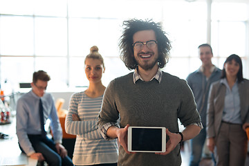 Image showing Portrait of a young businessman holding tablet