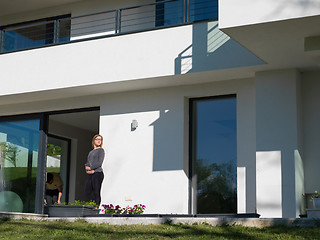 Image showing women using tablet computer in front of luxury home villa