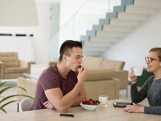 Image showing couple enjoying morning coffee and strawberries