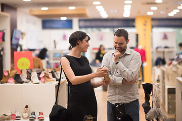 Image showing couple chooses shoes At Shoe Store