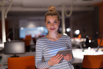 Image showing woman working on digital tablet in night office