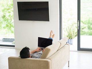 Image showing Man using laptop in living room