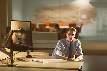 Image showing man working on computer in dark office