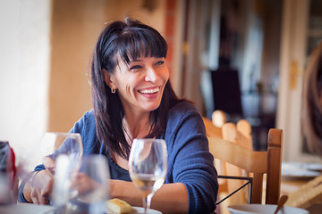 Image showing Pretty Italian Woman Enjoys A Meal And Drinks with Friends at Ou