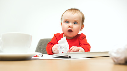 Image showing Happy child baby girl toddler sitting with keyboard of computer isolated on a white background