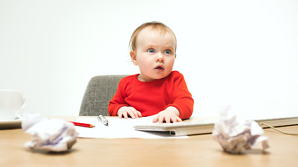 Image showing Happy child baby girl toddler sitting with keyboard of computer isolated on a white background