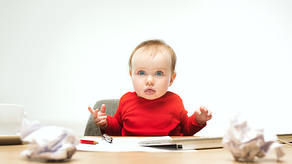 Image showing Happy child baby girl toddler sitting with keyboard of computer isolated on a white background