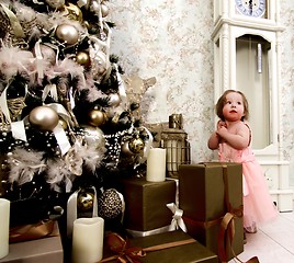 Image showing Little Girl Waiting Christmas Gifts