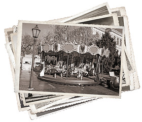 Image showing Old fashioned french carousel with horses Stack of old photos 