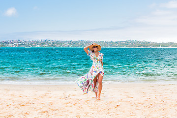 Image showing Female walking along a secluded beach in Sydney Harbour
