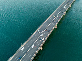 Image showing Vehicles on bridge over water