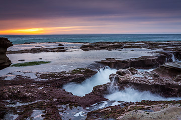 Image showing Ocean eroding out channels in the rocks