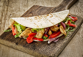 Image showing Tortilla wrap with fried chicken meat and vegetables