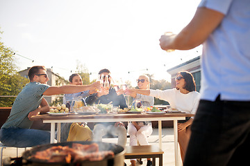 Image showing friends toast drinks at barbecue party on rooftop