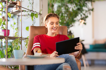 Image showing happy woman with tablet pc at cafe or coffee shop