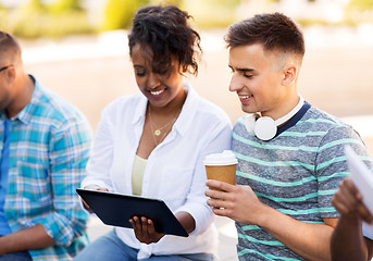 Image showing happy friends with tablet pc and coffee outdoors