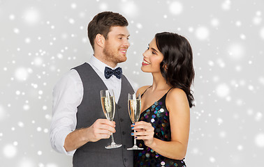 Image showing happy couple with champagne celebrating christmas