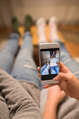 Image showing close up of couple taking foot photo by smartphone