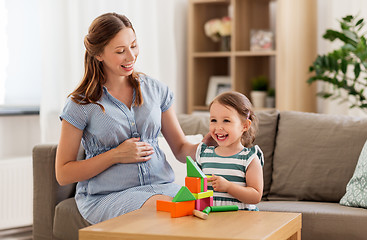 Image showing pregnant mother and daughter with toy blocks