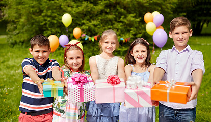 Image showing happy kids with gifts on birthday party at summer