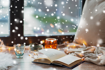 Image showing book, garland lights and candles on window sill