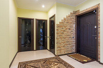 Image showing Spacious entrance hall in the apartment, three doors to the room, bathroom and toilet