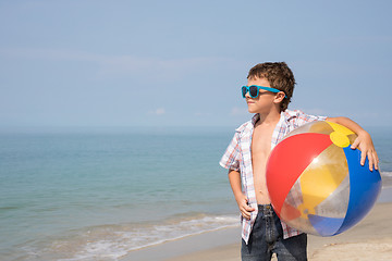 Image showing One happy little boy playing on the beach at the day time.