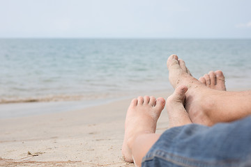 Image showing Father and son playing on the beach at the day time.