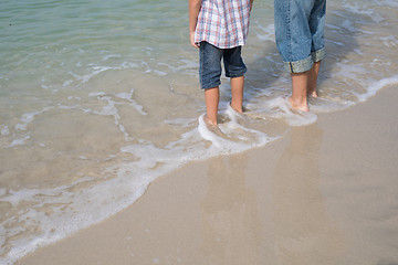 Image showing Father and son playing on the beach at the day time.