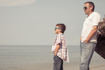 Image showing Father and son playing on the beach at the day time.