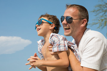 Image showing Father and son playing on the beach at the day time.