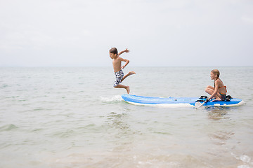 Image showing Happy children playing on the beach at the day time.